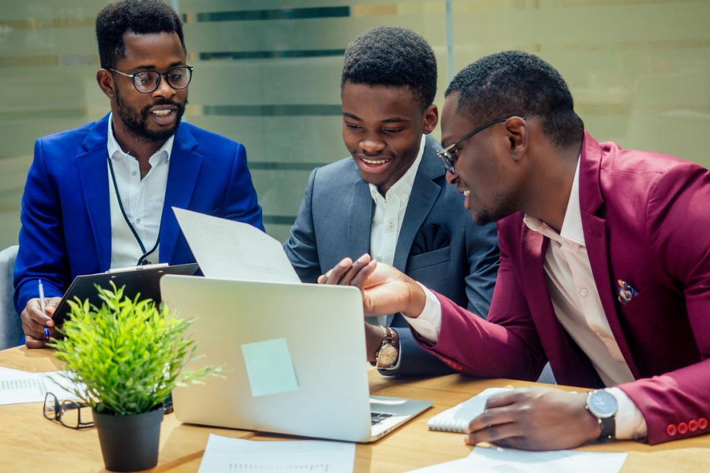 mixed race business people sitting in modern office copy space